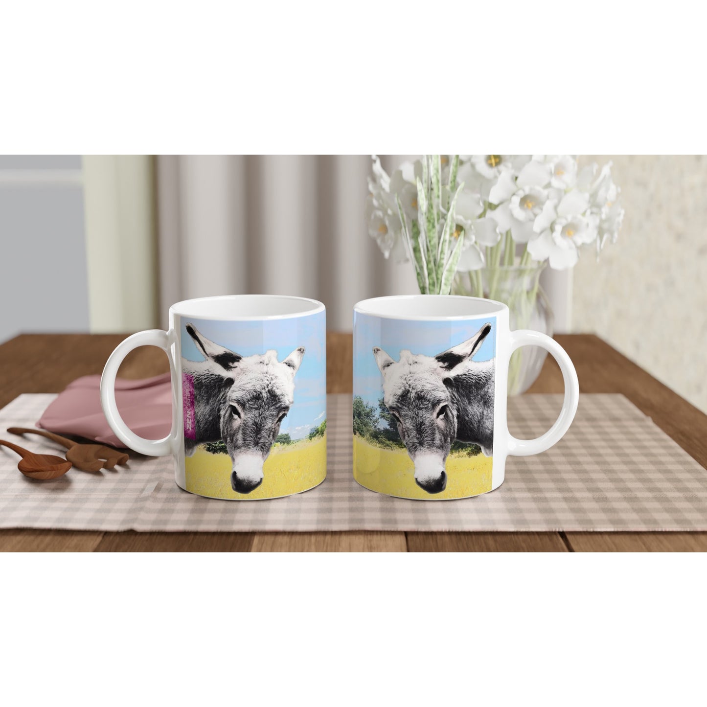 taza decorada con paisaje natural y dos burritos