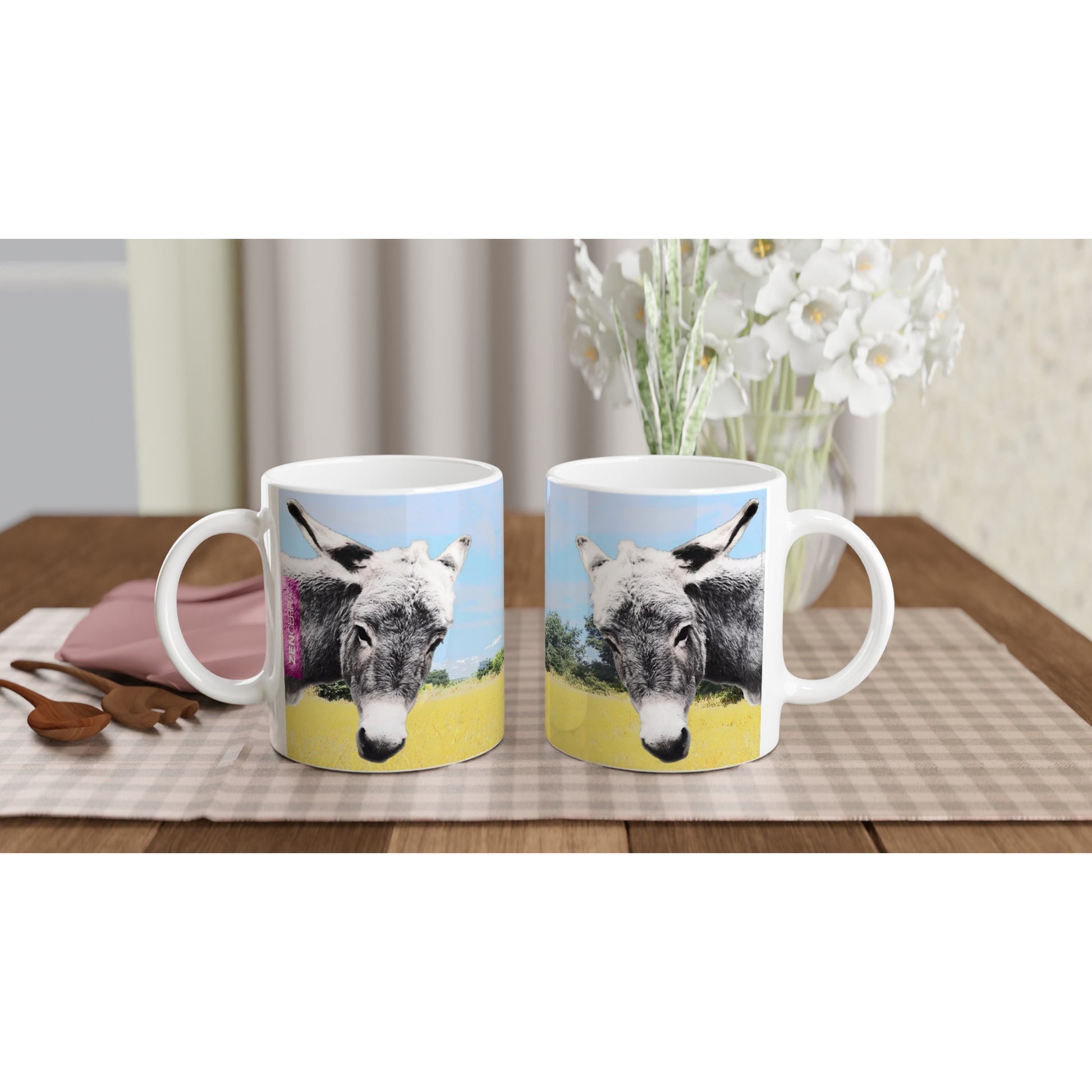 taza decorada con paisaje natural y dos burritos